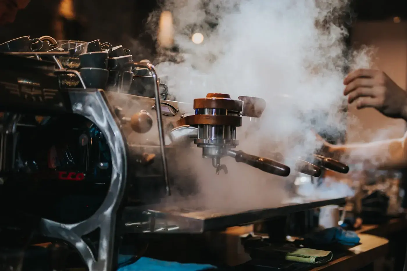 Steam rising from a commercial espresso machine during service